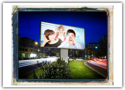 The image depicts a median strip in the evening, with traffic flowing on both sides, and an illuminated billboard featuring a photo of a man shouting, a woman looking, and a woman listening. When you hover over the image, a brief description appears: Perceive – Implement the communication plan and ensure mutual exchange with the target group.<br />©memephoto